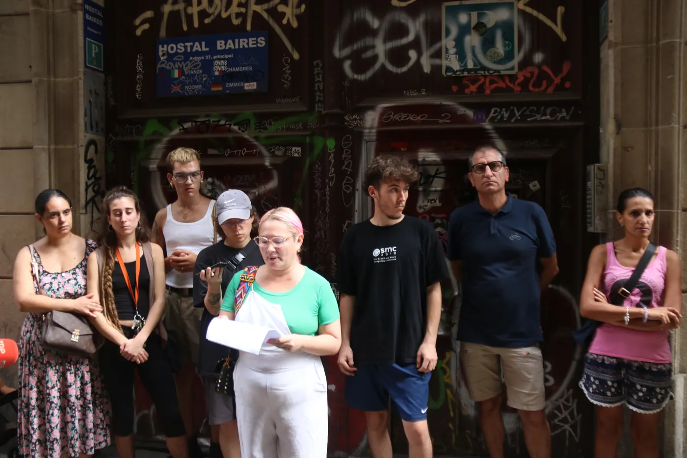 Membres de Raval Rebel llegeixen un manifest en contra de desallotjament a la porta de l’hostal on viu la família.
