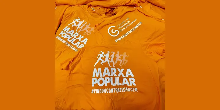 Marxa Popular Lluita contra el Càncer de Pineda: samarretes i tiquets a la venda a la pl. de les Mèlies i Centre Cívic Poblenou